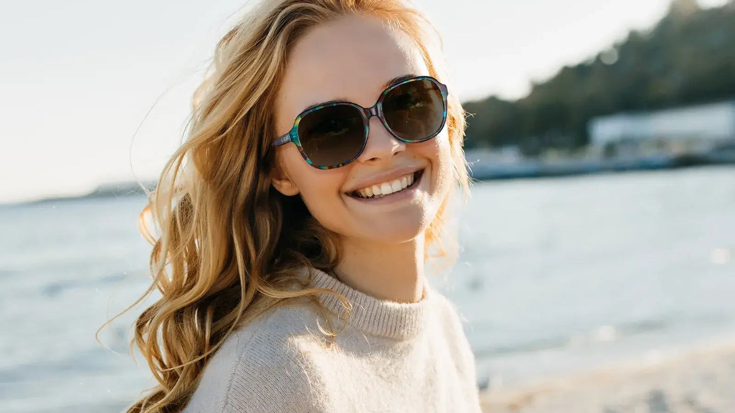 Woman at the beach wearing tortoise prescription sunglasses