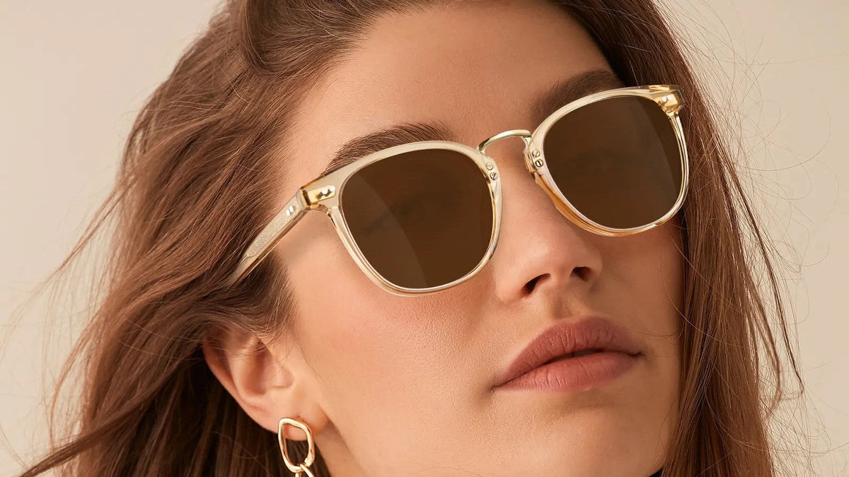 Woman wearing clear yellow cat-eye sunglasses with amber lenses