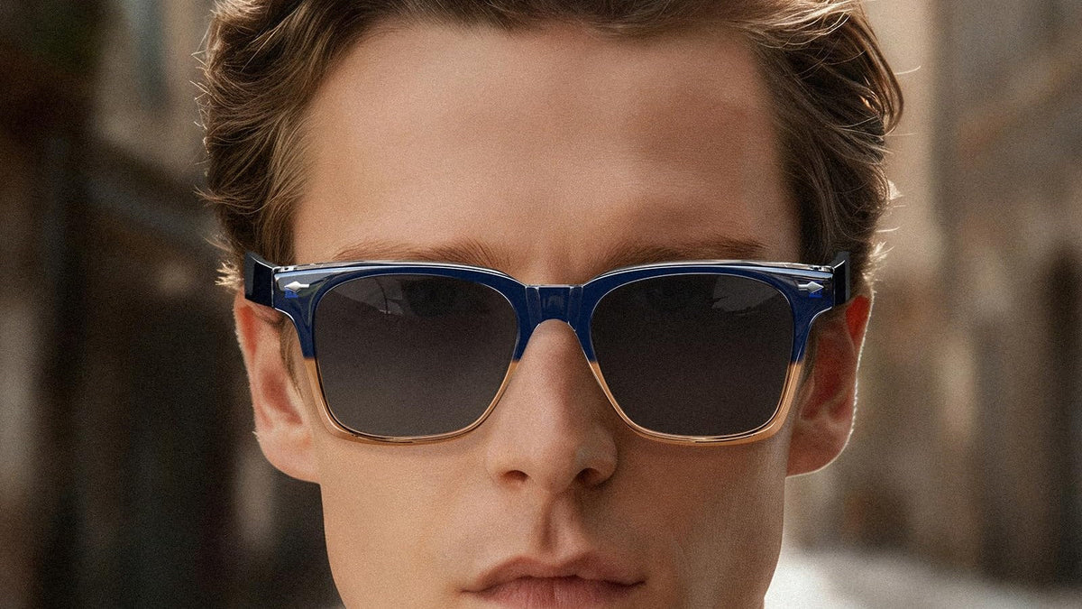 Man wearing blue square polarized sunglasses on a city street
