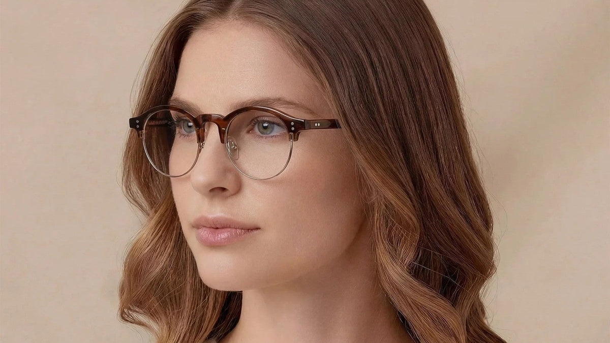 Woman with auburn hair wearing round tortoiseshell prescription glasses