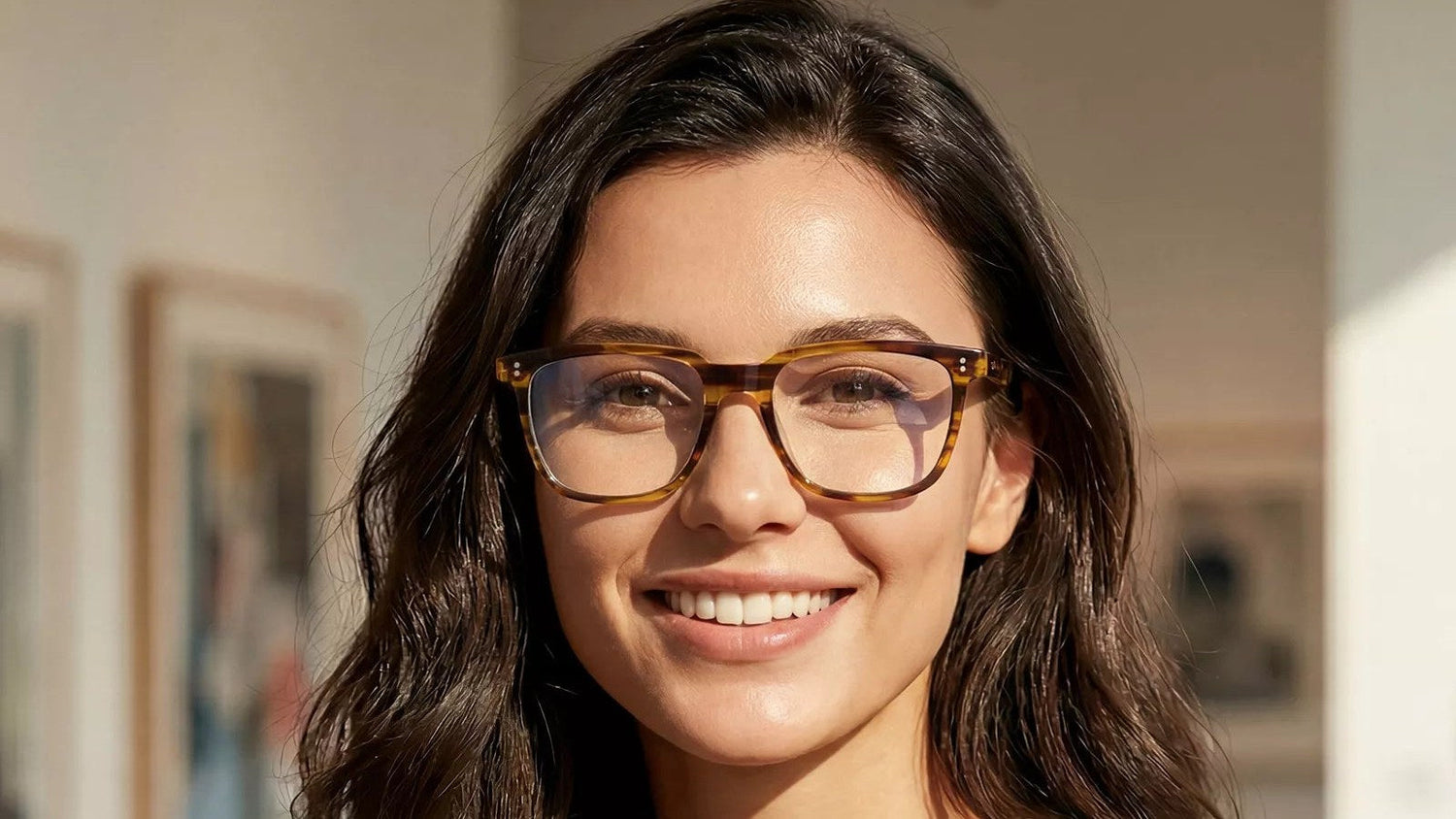 Woman wearing tortoise square prescription eyeglasses, looking straight ahead