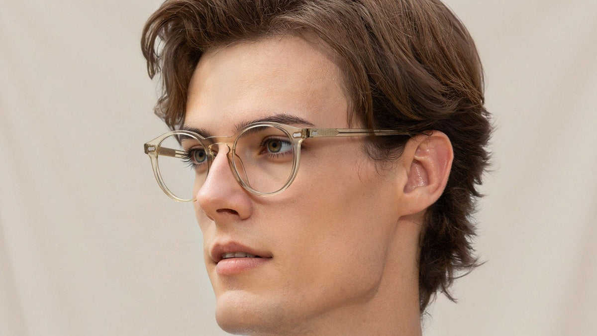 Man wearing clear round acetate eyeglasses