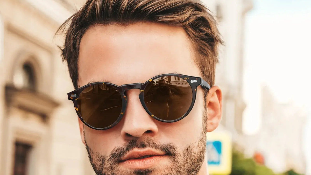 Man wearing round tortoise polarized sunglasses on a city street