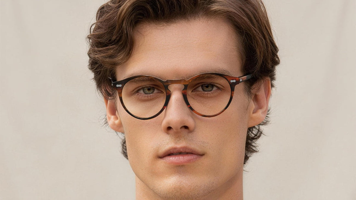Man wearing round tortoiseshell glasses with a keyhole bridge