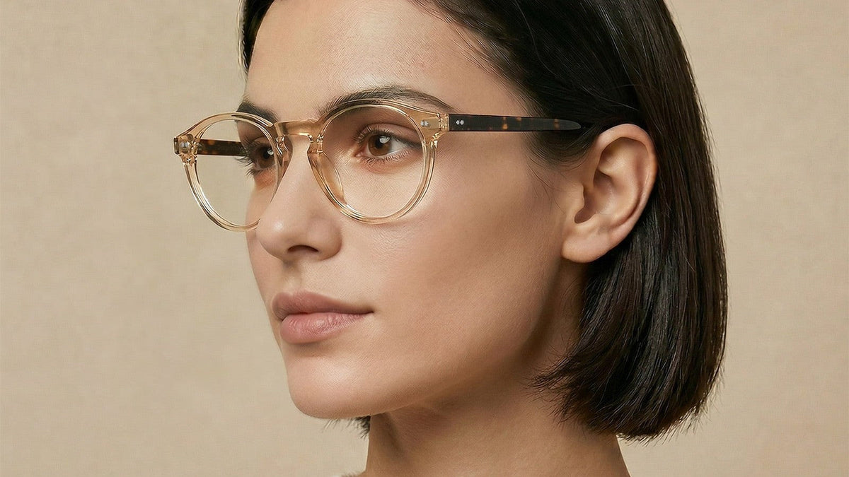 Woman wearing clear honey acetate round eyeglasses