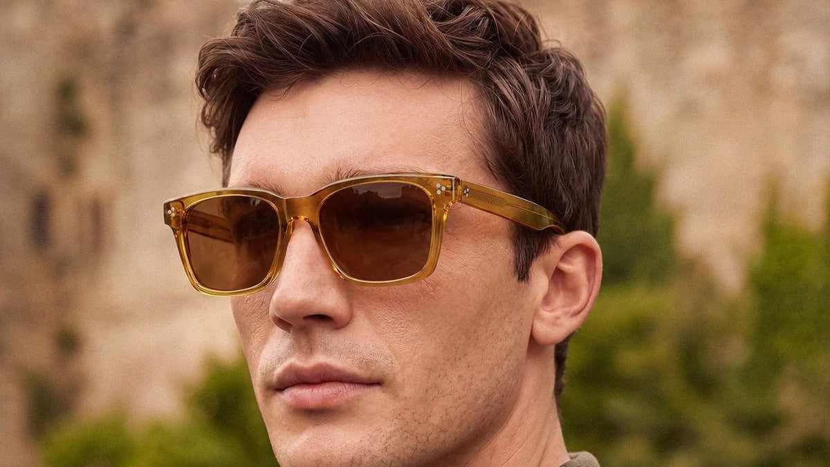 Man wearing amber tinted sunglasses outdoors