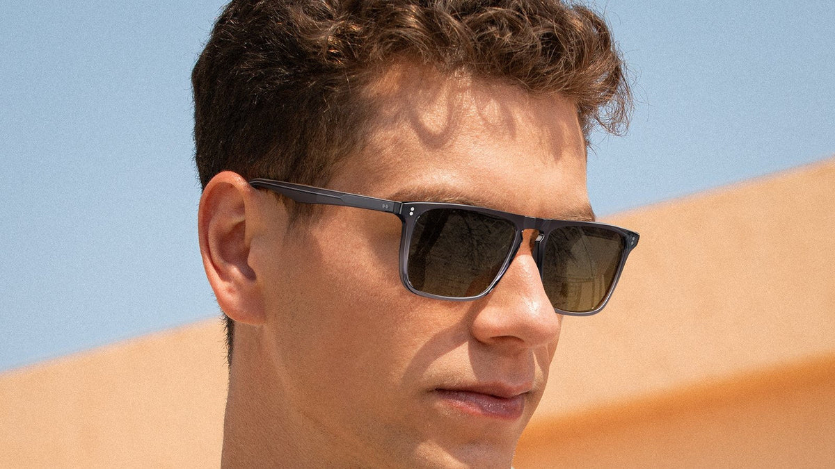 Man wearing rectangle acetate sunglasses with spring hinges outdoors