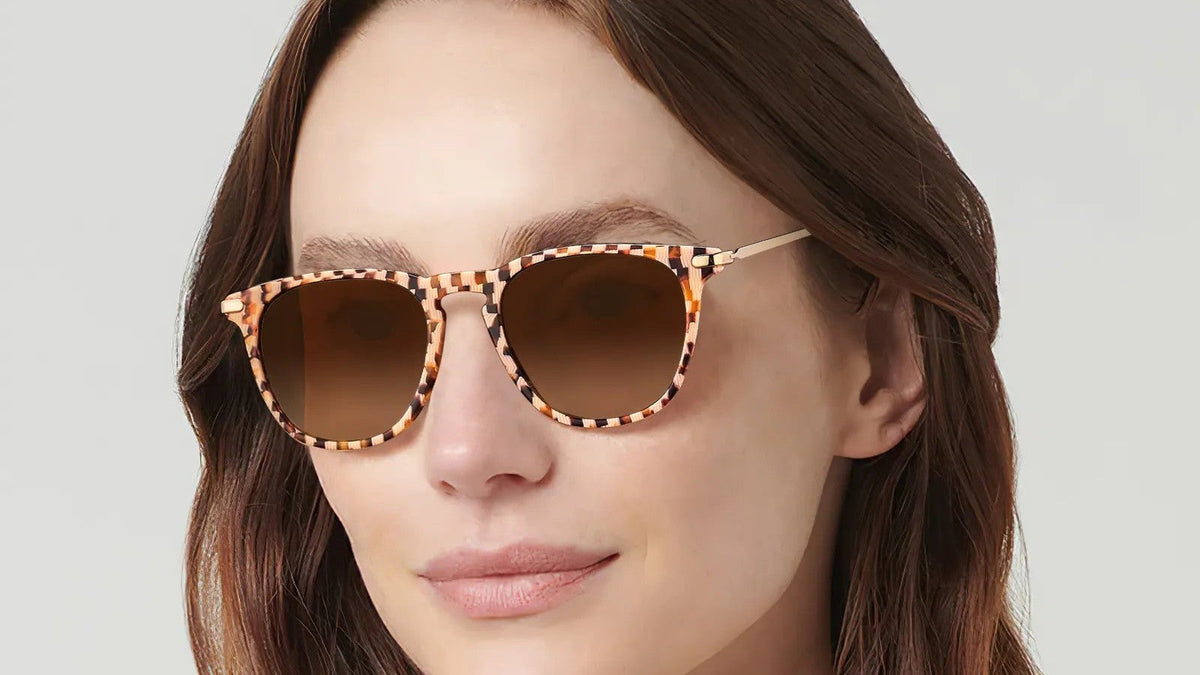 Woman wearing tortoiseshell round-square sunglasses with brown lenses
