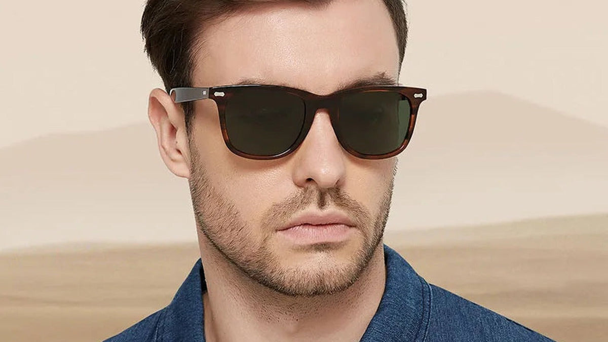 Man wearing brown acetate sunglasses against a desert backdrop