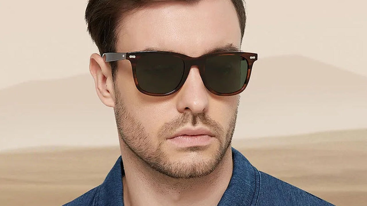 Man wearing brown acetate sunglasses against a desert backdrop