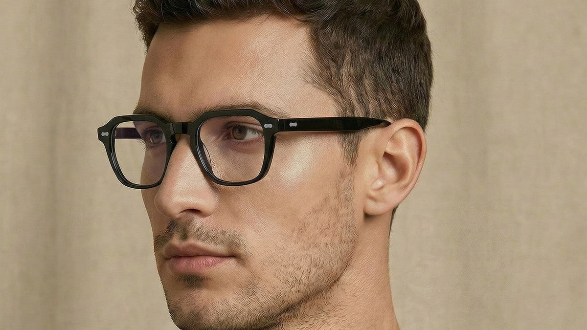 Man with a broad face wearing black square acetate eyeglasses