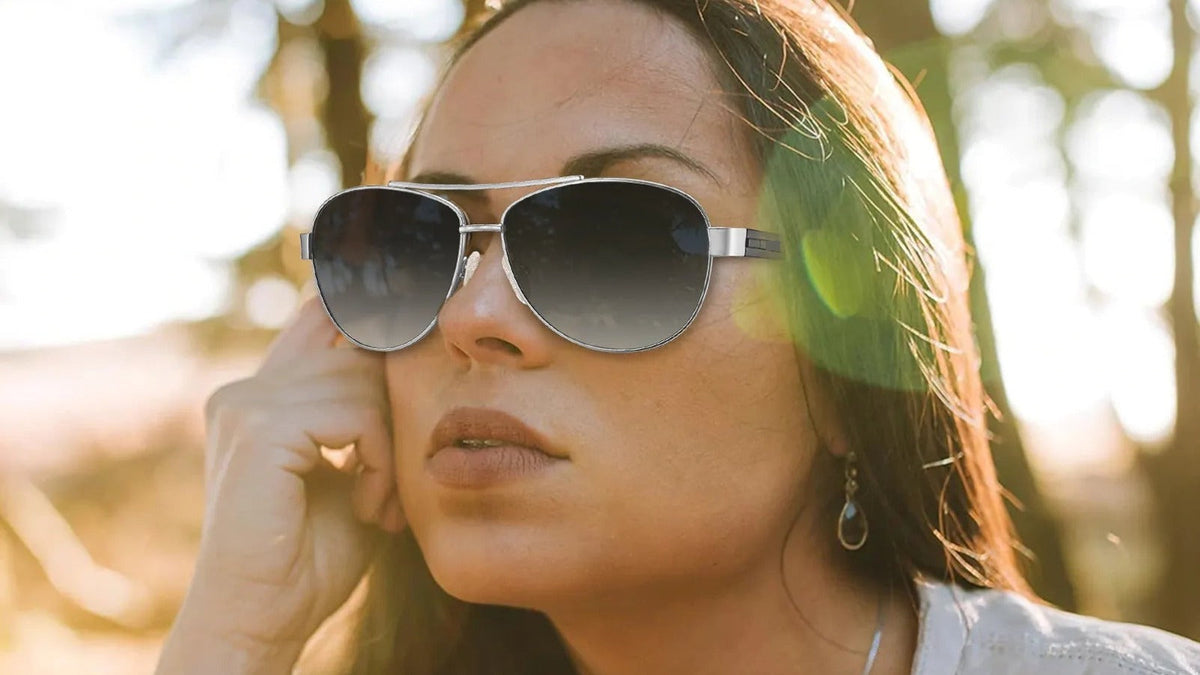 Woman wearing aviator sunglasses in low winter sun